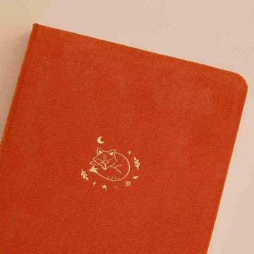 Close up of the front cover of Tsuki ‘Kitsune’ Limited Edition Fox Bullet Journal on beige background